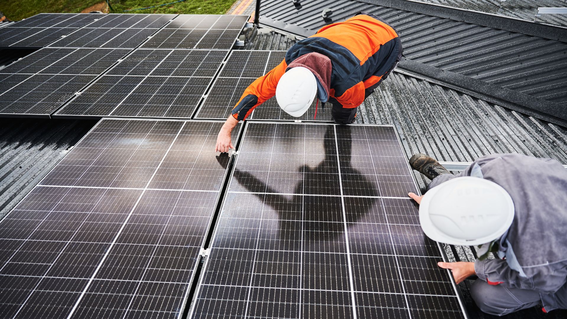 solar technicians in action inspecting an open inverter panel with visible components