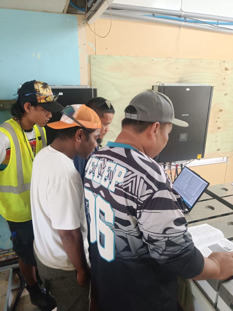 Pacific island solar training participants troubleshooting inverter connection issues